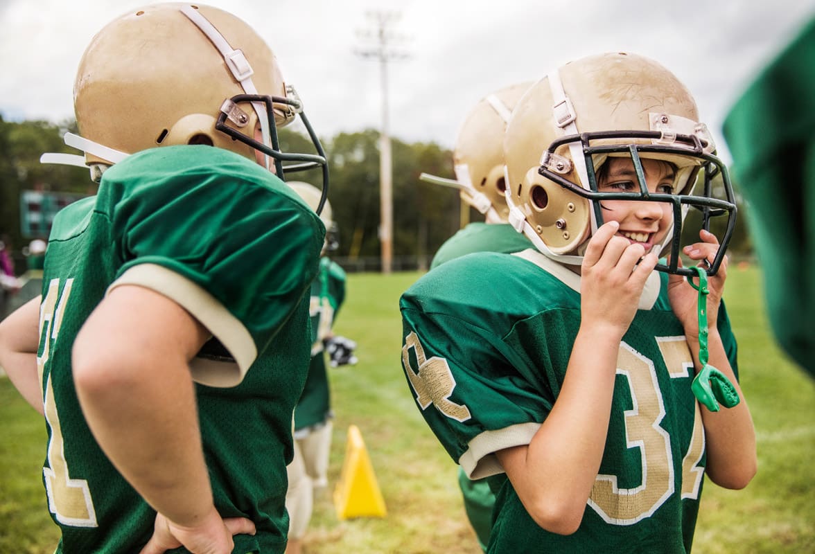 Boys (10 11) playing american football